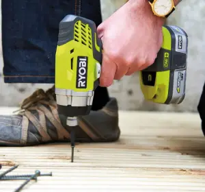 Impact driver in use drilling screws into decking